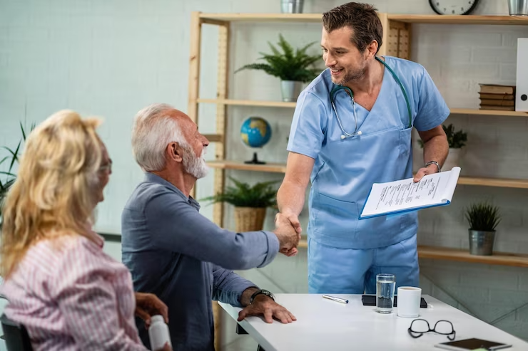 happy-healthcare-worker-mature-couple-greeting-his-office-men-are-shaking-hands
