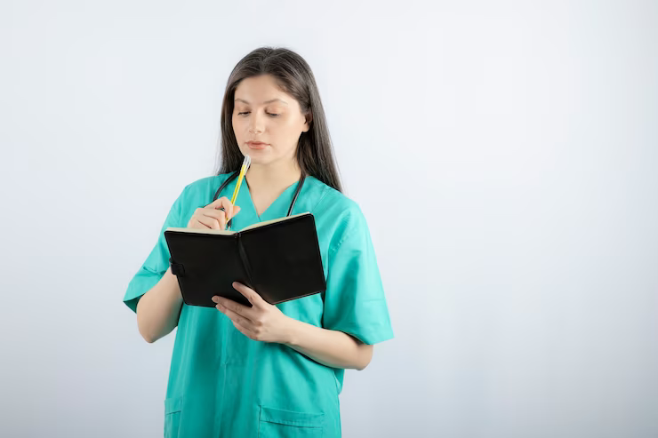 young-female-doctor-standing-with-notebook-pencil